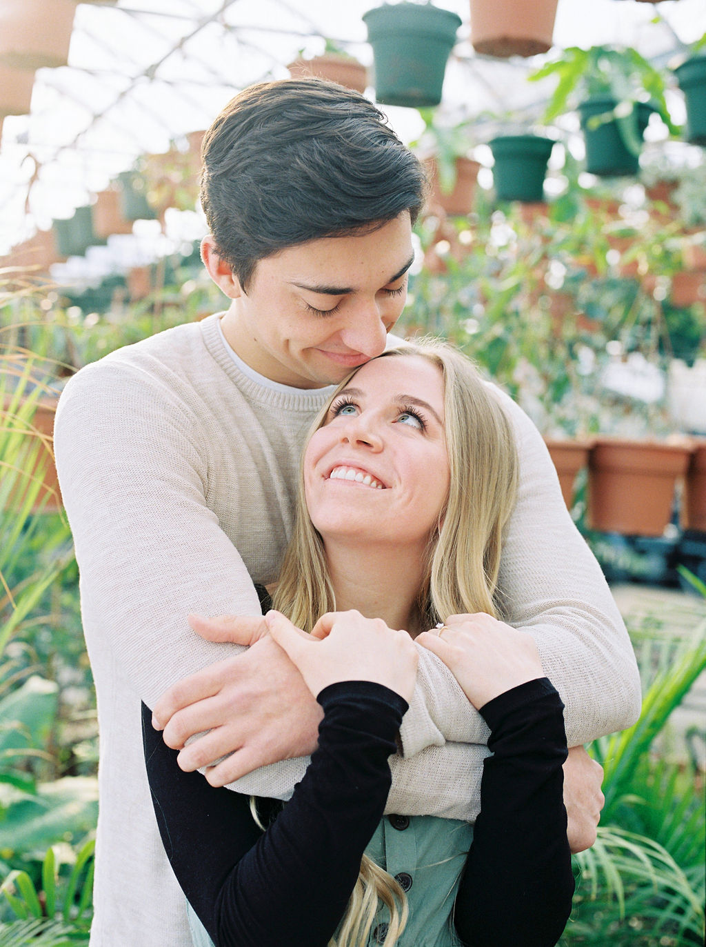 Engaged Couple Bear Hug Greenhouse