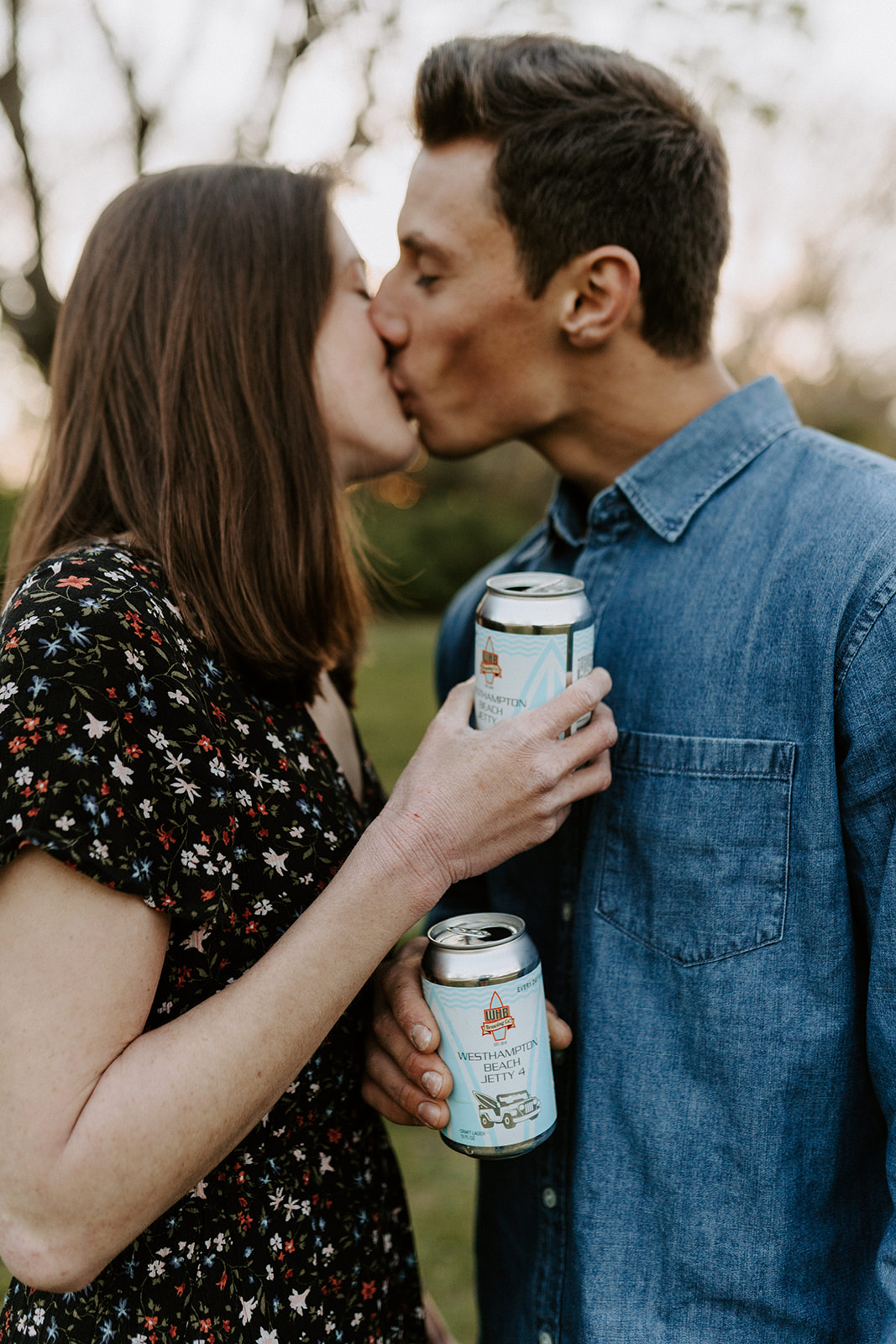 couple holding beer in engagement session