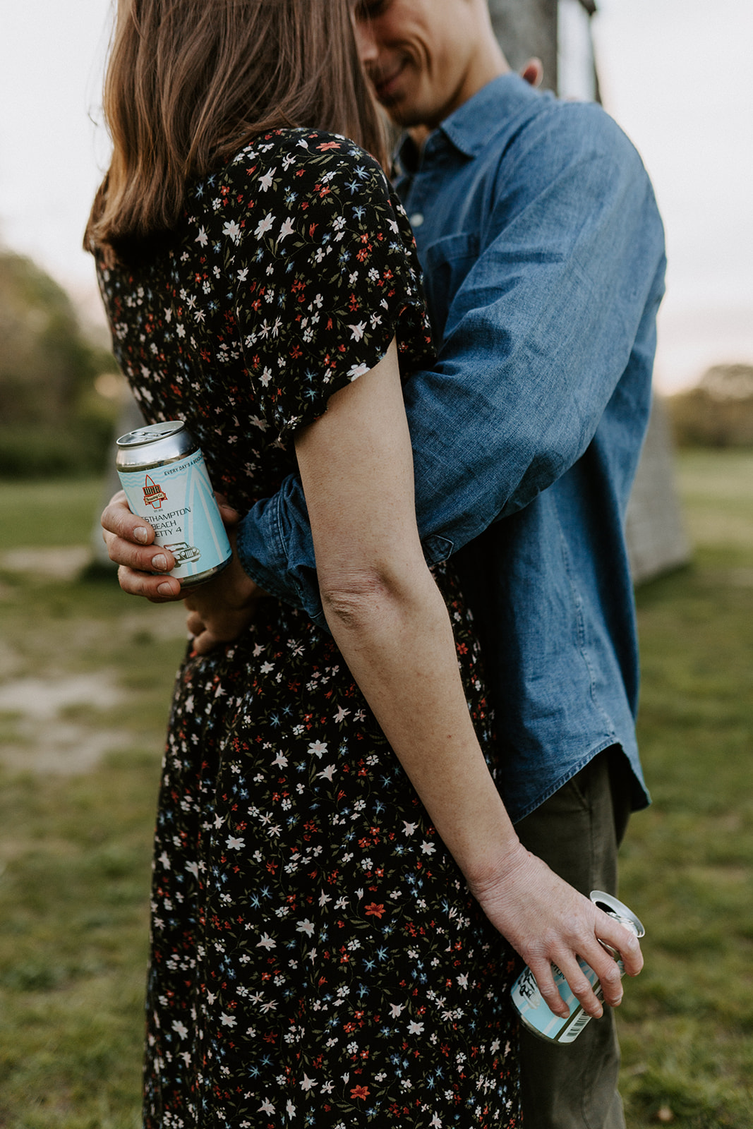 couple holding beer in engagement session