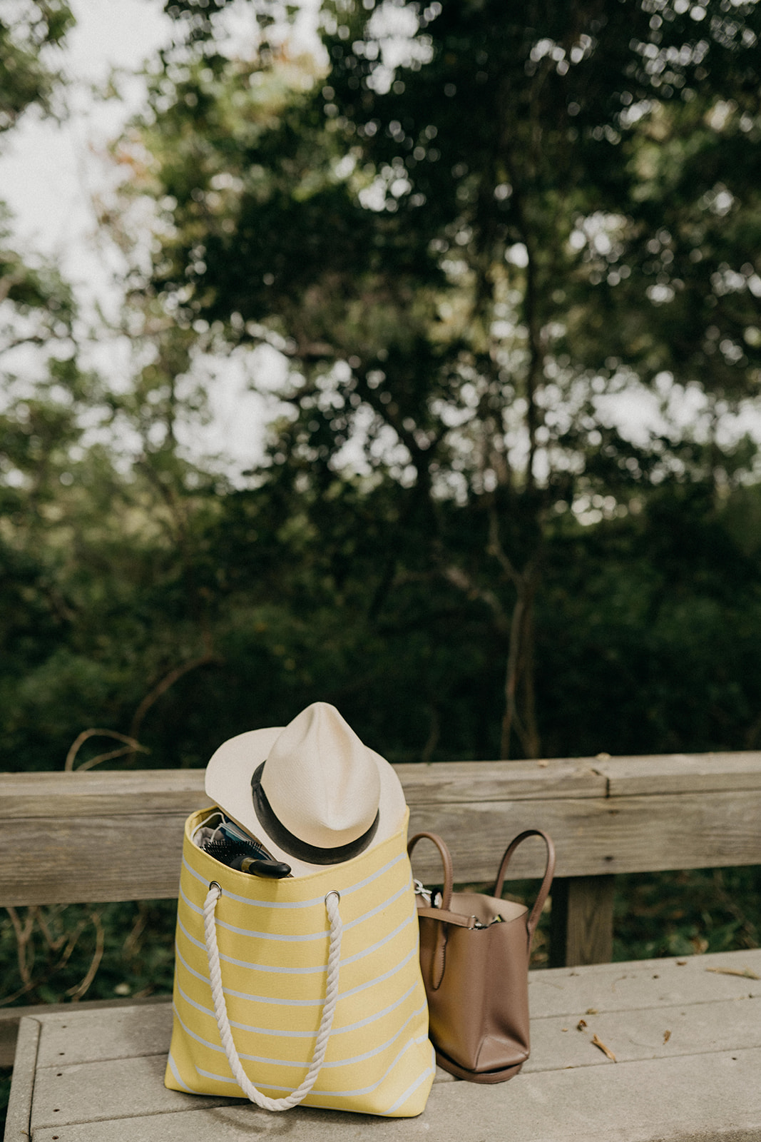 bag with panama straw hat in a bag during an engagement session