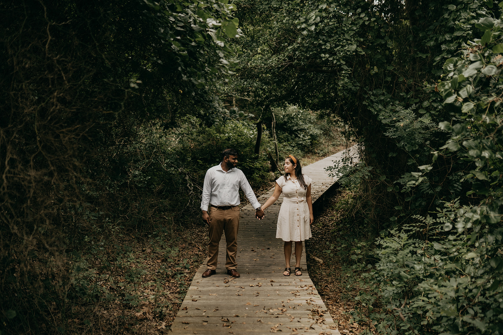 engaged session with couple holding hands and walking
