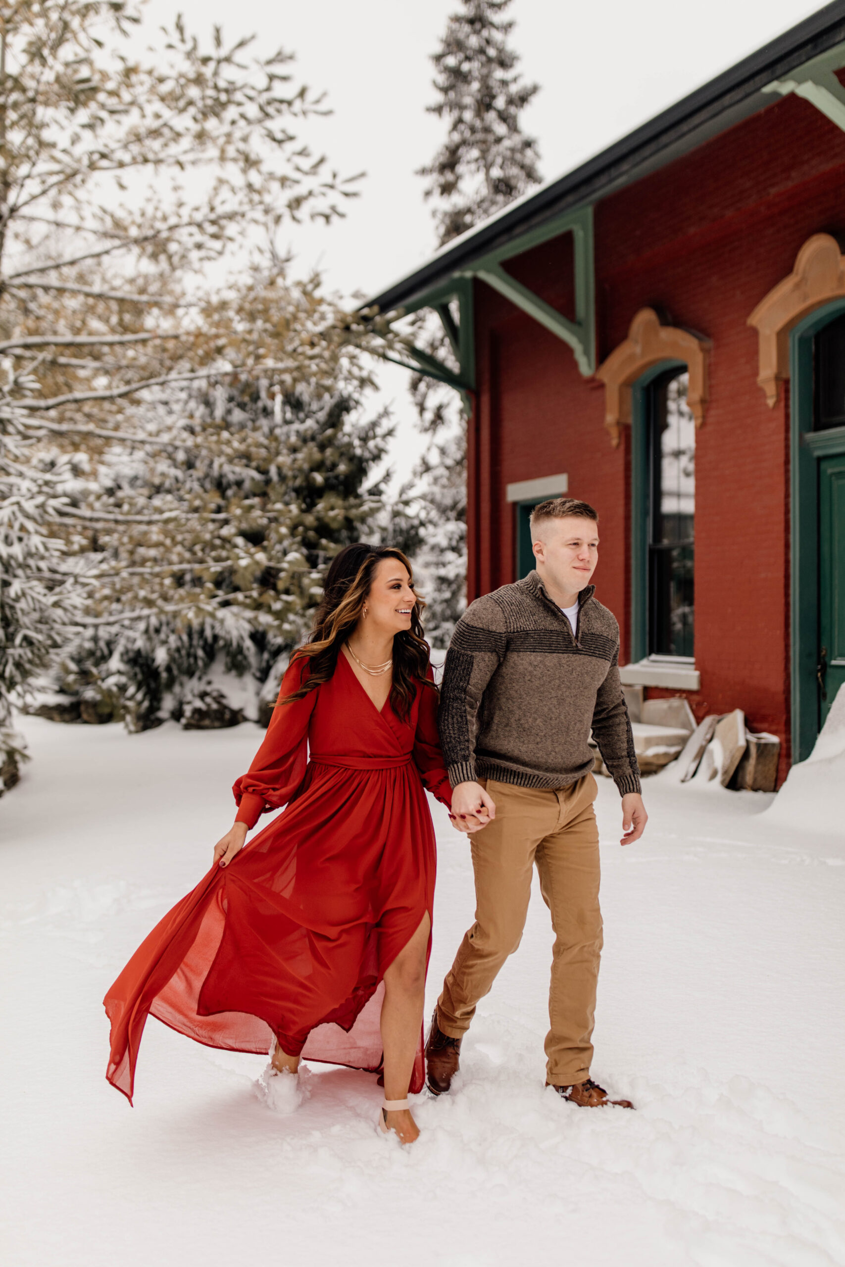 Engaged Couple Walking In Snow